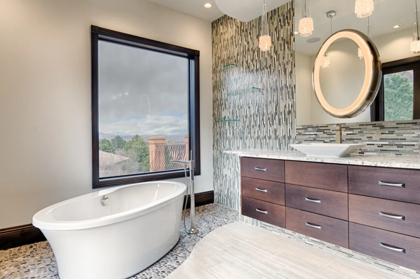 A finished master bath with a freestanding tub and a custom vanity